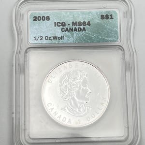May include: A silver Canadian 1 dollar coin, in a clear protective case. The coin shows Queen Elizabeth II and the words "CANADA 1 DOLLAR". The case has a label with "2006", "ICQ-MS64 CANADA", and "1/2 Oz, Wolf".