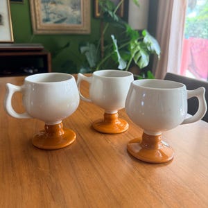 Vintage Caribe Pottery Mugs Set of 3 | MCM Orange White Pedestal Coffee Cups | Retro Ceramic Barware
