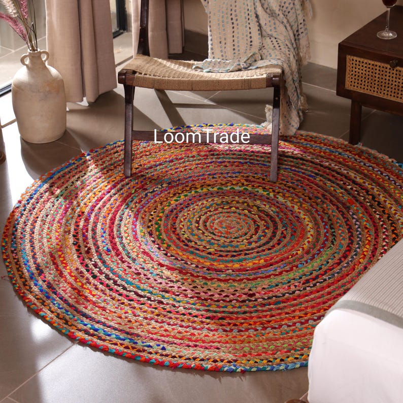May include: A circular jute rug with a braided design, showcasing a vibrant array of colours such as red, blue, yellow, and green. The rug has the text "LoomTrade" on it. This rug is suitable for home decor.Handwoven Multicolor Bohemian Cotton braided round chindi circle rugs for home decor and dining room decor Vintage boho circle area Doormat
chindi round rug, braided round rug, round jute rugs, cotton braided rug, custom size rug, cotton jute rug, eco friendly rugs, bohemian rug, boh