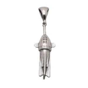 May include: A silver pendant shaped like a submarine with a detailed design. The pendant has a loop at the top for attaching to a chain.