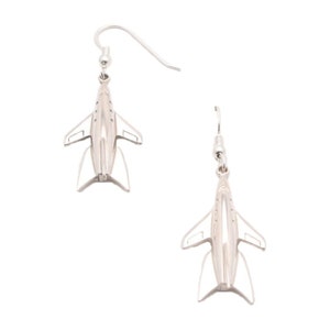 May include: Silver airplane dangle earrings. The earrings are silver and feature a detailed airplane design.