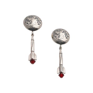 May include: Silver earrings with a textured moon design and a rocket pendant with a red crystal at the bottom.