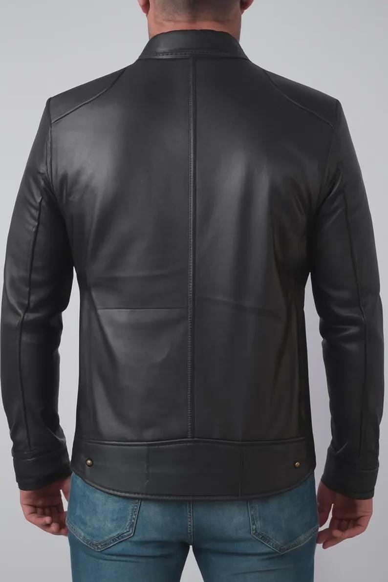 May include: A black leather jacket with a stand-up collar and a tailored fit. The jacket features a vertical seam down the back and two small gold-colored buttons at the waist. The sleeves are long and fitted.