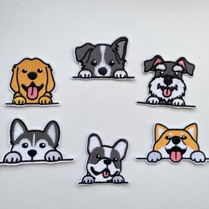 Könnte beinhalten: Sechs gestickte Hundeaufnäher mit verschiedenen Rassen, jede mit einem einzigartigen Ausdruck. Die Hunde sind in verschiedenen Farben, darunter Gold, Schwarz, Weiß und Grau. Jeder Aufnäher hat einen schwarzen Rand und ist so gestaltet, als würden die Hunde über eine Kante schauen.