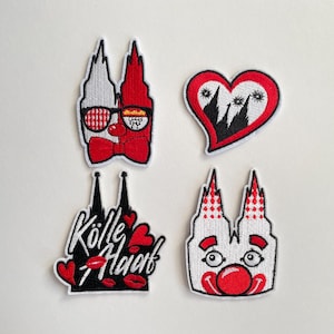 Könnte beinhalten: Vier gestickte Aufnäher mit Motiven des Kölner Doms. Einer zeigt einen Dom mit Sonnenbrille und Fliege. Ein weiterer ist ein Herz mit einer Dom-Silhouette. Der dritte Aufnäher hat den Text "Kölle Alaaf" mit Herzen und Lippen.