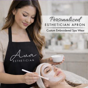 May include: A black esthetician apron with the name "Ava" and the word "ESTHETICIAN" in white script. The apron is worn by a person applying a facial mask. Text on the image reads "Personalized ESTHETICIAN APRON Custom Embroidered Spa Wear."