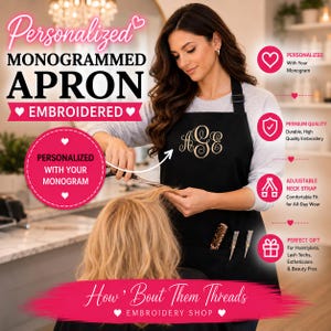 May include: A black apron featuring a gold embroidered monogram on the chest and two front pockets containing a leopard print comb and two silver hair styling tools. The apron has an adjustable black neck strap and is worn over a gray long-sleeve shirt.