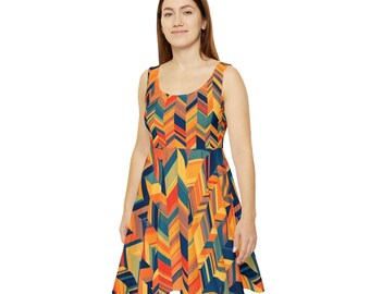 Puede incluir: Vestido sin mangas con un vibrante estampado geométrico en tonos naranja, amarillo, azul y rojo. El vestido tiene un escote redondo y una falda acampanada, creando un look juguetón y llamativo. El diseño presenta un patrón de chevrón repetido.
