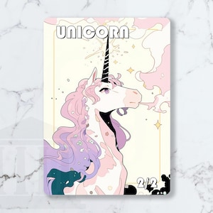 May include: A fantasy illustration of a unicorn with a black horn, pink mane, and a light yellow background. The word "UNICORN" is at the top. The unicorn is exhaling a cloud of pink smoke. The card has the numbers "2/2" at the bottom.