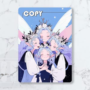 May include: A rectangular print featuring five stylized figures with blue hair, floral crowns, and wings. The figures are embracing, set against a blue sky with stars. The word "COPY" is at the top.