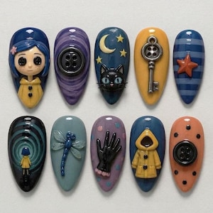May include: A set of ten almond-shaped press-on nails featuring 3D designs inspired by Coraline. Elements include a character with blue hair and a yellow raincoat, black buttons, a cat face with a crescent moon, a skeleton key, and a dragonfly.