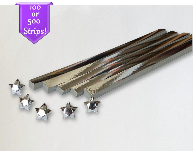 Puede incluir: Tiras de papel de origami plateadas, 100 o 500 tiras, con cinco estrellas de origami plateadas.