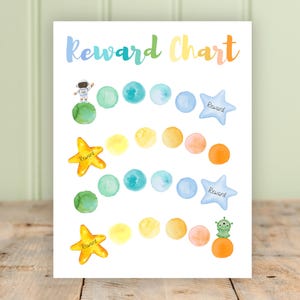 May include: Watercolor reward chart with the text "Reward Chart" in rainbow colors. The chart features planets, stars, and colorful dots. An astronaut and an alien are also depicted.