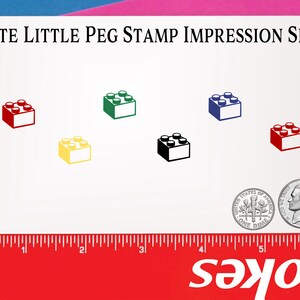 May include: A white card with the text "Cute Little Peg Stamp Impression Size" printed in black. The card shows the size of a stamp impression in the shape of a Lego brick in six different colors: red, yellow, green, black, blue, and dark red. The card also includes a ruler and a US dime for size comparison.