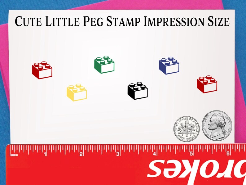 May include: A white card with the text "Cute Little Peg Stamp Impression Size" printed in black. The card shows the size of a stamp impression in the shape of a Lego brick in six different colors: red, yellow, green, black, blue, and dark red. The card also includes a ruler and a US dime for size comparison.