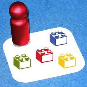May include: A red rubber stamp with a design of a Lego brick. The stamp is on a white surface with four different colored Lego brick designs. The designs are blue, red, green, and yellow.