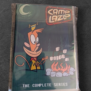May include: A sealed DVD set of the animated series "Camp Lazlo." The cover art features a cartoon monkey roasting marshmallows over a campfire, with the show's logo and the text "THE COMPLETE SERIES."