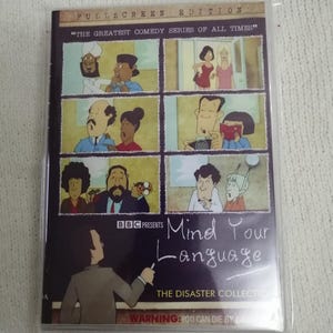 May include: A DVD of the comedy series "Mind Your Language". The cover shows cartoon panels of characters and the show's title in white script. The DVD is in a clear plastic sleeve.