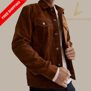 May include: A brown suede jacket with silver buttons and two chest pockets. The jacket has a classic design and is from London Lux Leather. The words "FREE SHIPPING" are in a red banner in the upper left corner.