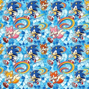 May include: A repeating pattern featuring the character Sonic the Hedgehog, running with a rainbow trail, alongside other characters. The background is a mosaic of blue tiles. The characters are in motion.