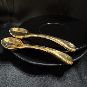 Set 2 - Black and Gold Dishes with Gold Spoon attached.