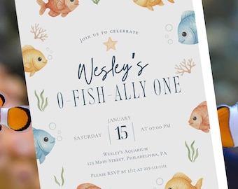 May include: An invitation with a watercolor design featuring cartoon fish in shades of orange, yellow, and blue. The text reads "Wesley's O-Fish-Ally One" with event details including the date, time, and location: Wesley's Aquarium, Philadelphia, PA.