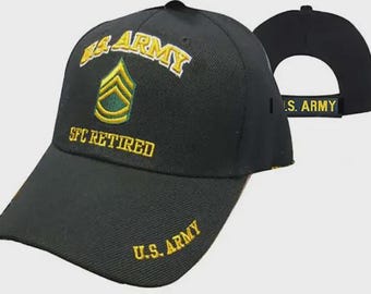 May include: A black baseball cap featuring yellow embroidered text that reads U.S. ARMY and SFC RETIRED, along with a green and yellow sergeant first class rank insignia. The brim displays U.S. ARMY in yellow, and the back strap features U.S. ARMY.