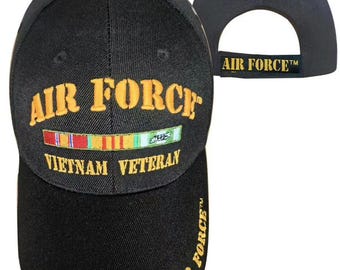 May include: A black baseball cap featuring the embroidered yellow text AIR FORCE and VIETNAM VETERAN on the front, with a colorful ribbon bar graphic in between. The word AIR FORCE is also embroidered in yellow on the brim and the back strap.