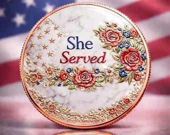 May include: A round, decorative item with the text "She Served" in blue and red. The item features a marble-like background, gold trim, and floral embellishments in red, blue, and white. Gold stars are on the left side.