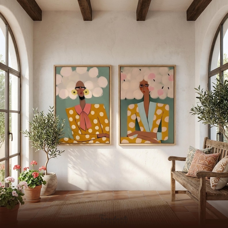 Funny bathroom art print set — two bold women with side-eye expressions in mustard polka dot suits, wood framed diptych, Mediterranean entryway with arched windows and terracotta tile floor
