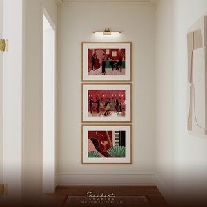 Gallery wall set in a hallway featuring three vertical frames including the jazz dance scene and saxophone players, creating a cohesive African American art collection.