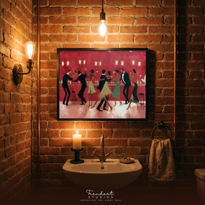May include: A framed artwork of a jazz club scene with dancing figures hangs on a brick wall. A lit candle, a sink with a brass tap, and a towel ring are below the artwork. The image is illuminated by a light bulb.