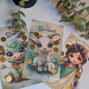 Könnte beinhalten: Drei illustrierte Karten mit Tierkreiszeichen. Die mittlere Karte zeigt eine Ziege mit dem Wort "Steinbock". Die anderen Karten zeigen einen Stier und eine Frau. Jede Karte hat goldene Akzente und eine Reihe goldener Kreise.