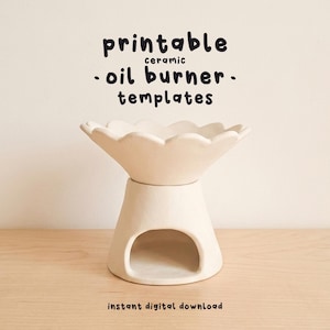 May include: A cream ceramic oil burner with a flower-shaped top and a rounded base. The text "printable ceramic oil burner templates" is displayed above the burner. The words "instant digital download" are below the burner.