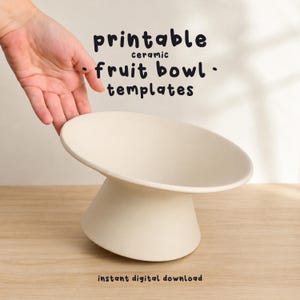 May include: A matte off-white ceramic fruit bowl with a wide, flared rim and a pedestal base. The text "printable ceramic fruit bowl templates" and "instant digital download" is displayed in black, rounded, sans-serif lettering above and below.