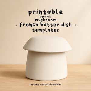 May include: A cream ceramic mushroom-shaped French butter dish. The image includes the text "printable ceramic mushroom - french butter dish - templates" and "instant digital download". The dish is on a wooden surface.