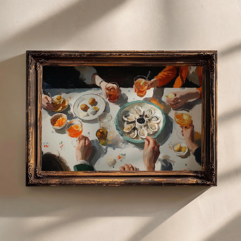 May include: A framed painting depicts a dining scene with a table set for a meal. The table is adorned with plates of food, drinks, and a central platter of oysters. The artwork features a warm color palette and captures a moment of gathering.