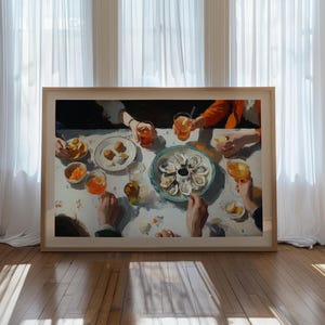 May include: A framed painting depicts a gathering around a table laden with food and drinks. The scene includes plates of oysters, appetizers, and glasses of orange-colored beverages. The artwork is set against a backdrop of white curtains and a wooden floor.