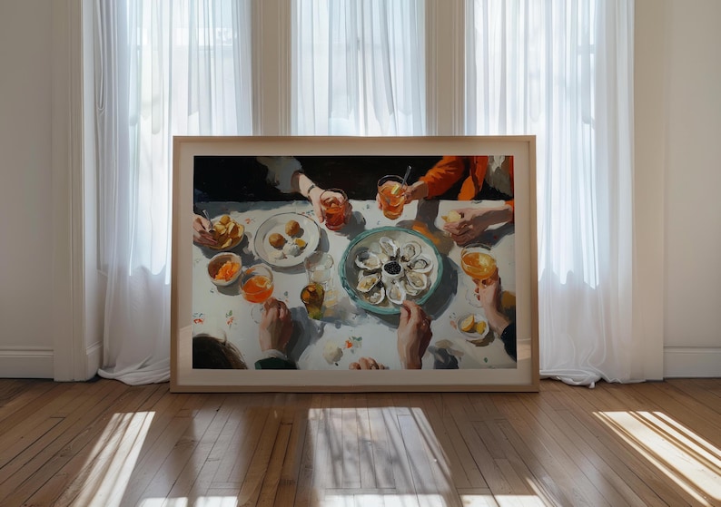 May include: A framed painting depicts a gathering around a table laden with food and drinks. The scene includes plates of oysters, appetizers, and glasses of orange-colored beverages. The artwork is set against a backdrop of white curtains and a wooden floor.