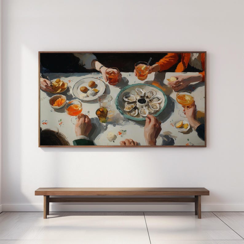 May include: A framed painting depicts a gathering around a table set with oysters, appetizers, and drinks. The artwork features a light color palette with visible brushstrokes, capturing a moment of social interaction. The painting is mounted above a wooden bench.