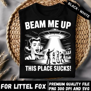 May include: Black t-shirt with a retro graphic of a UFO beaming up people. The text "BEAM ME UP" and "THIS PLACE SUCKS!" are in white. The design includes a vintage illustration of a woman, all on a black background.