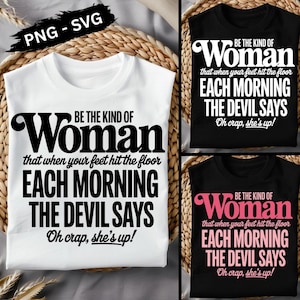 May include: Three t-shirts with the text "BE THE KIND OF Woman that when your feet hit the floor EACH MORNING THE DEVIL SAYS Oh crap, she's up!". One white, and two black shirts. The text is in black and pink.