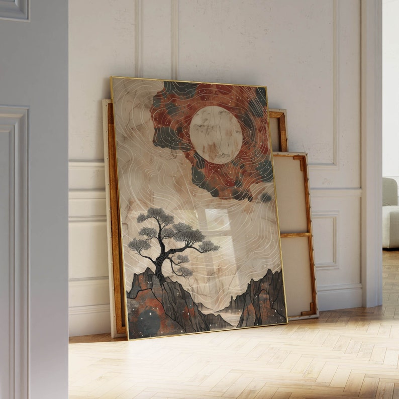 May include: A framed print with a watercolor-style design of a tree, mountains, and a large, red-orange moon with white stars. The background is a light beige with white lines and a dark blue and red-orange sky.