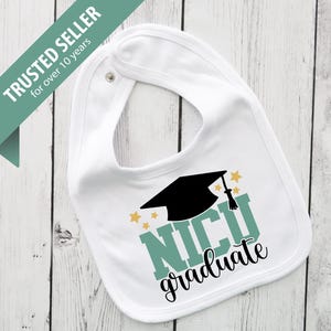 May include: White baby bib with a black graduation cap and the words "NICU Graduate" in teal and black. Gold stars accent the design. The bib has a snap closure and the text "TRUSTED SELLER for over 10 years" in the upper left corner.