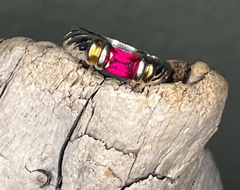 Estate ring signed 'EDCO' set with a red center stone that shines with pink hues