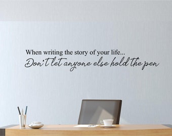 May include: A motivational quote on a white wall in a home office setting: "When writing the story of your life... Don't let anyone else hold the pen."
