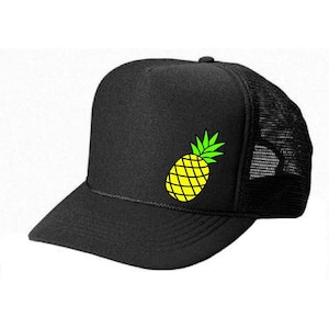 May include: A black trucker hat with a yellow pineapple graphic on the front. The hat has a black mesh back.