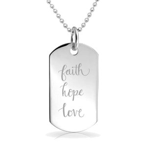 May include: A silver dog tag pendant with the words "faith, hope, love" engraved in a cursive font. The tag hangs from a ball chain necklace. The pendant is rectangular with rounded edges.