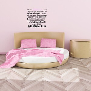 May include: A round bed with a pink blanket and two pink pillows. The wall behind the bed is pink and has a black text quote that reads: "Sugar and spice, they are made of... Sugar and spice, they are made of... cupcakes and crayons, butterflies and ballet shoes, tutus and tights, dresses and sandals, lollipops and lemonade, ponytails and polkadots, dress up days, and a lifetime of love."