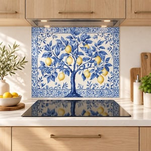 Blue lemon tree glass backsplash with yellow lemons and a decorative tile border above a stainless steel stove in a bright cream kitchen.